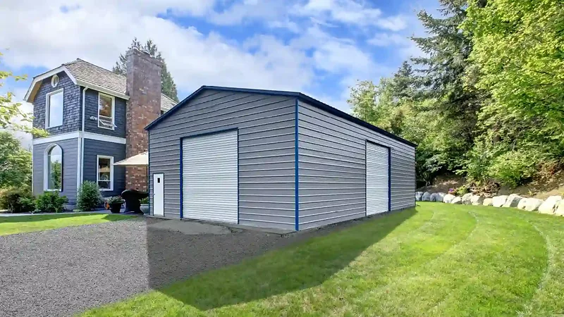 Photo of the Forge, a 30 by 50 foot tall steel shop with pewter gray walls and a pewter gray roof